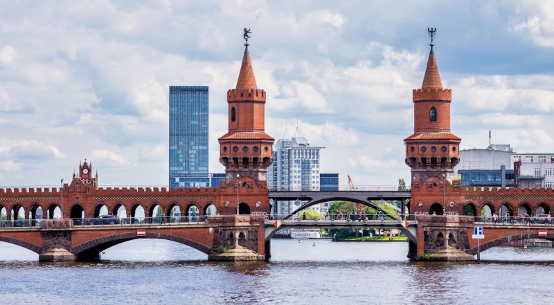 The Oberbaumbrücke between Friedrichshain and Kreuzberg in Berlin with the Allianz tower in Treptow in the background