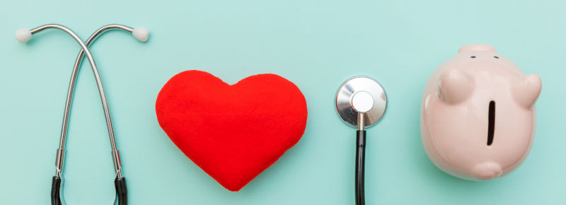 A stethoscope, a heart and a piggy bank