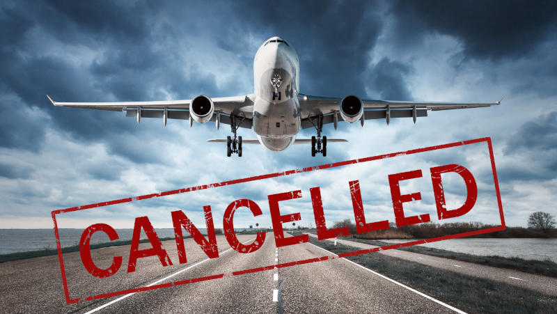 A plane taking off on the runway with red text Cancelled written on the image